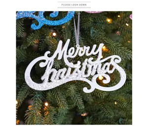 Close-up detail of white glitter Merry Christmas hanging sign ornament for holiday tree decor.