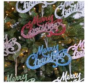 Closeup shot of colorful glitter Merry Christmas letter ornaments hanging on a green tree.