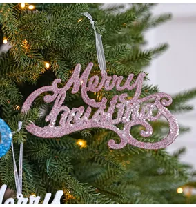 Pink glitter Merry Christmas hanging sign detail displayed on lush pine tree branches