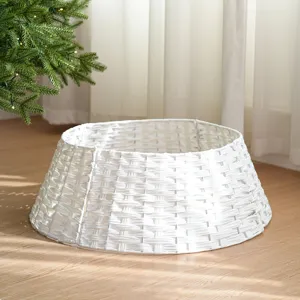 White plastic rattan Christmas tree collar detail, woven basket skirt for holiday decor.