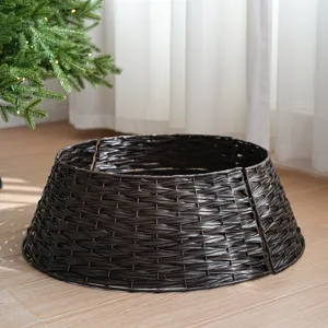 Dark brown plastic rattan Christmas tree collar, minimalist woven tree skirt decor detail.