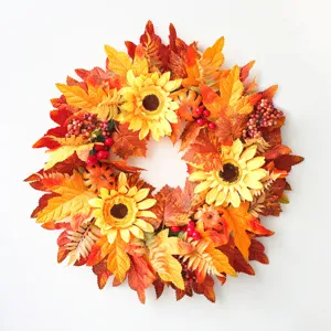 Autumn artificial wreath featuring sunflowers, maple leaves, and berries for Thanksgiving door hanging.