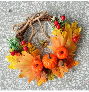 Autumn wreath detail shot featuring artificial maple leaves, pumpkins, and pinecones.