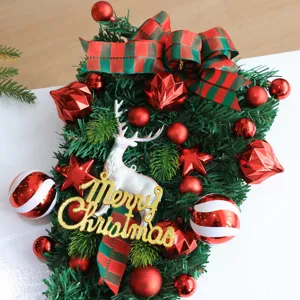 Christmas upside-down tree hanging decor with red balls, ribbon bow and cute deer. Festive.