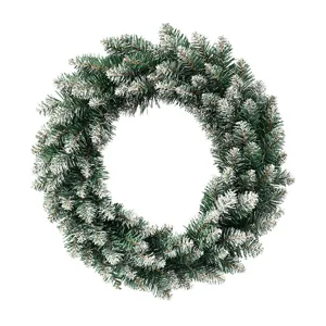 Snow-tipped artificial pine Christmas wreath for door hanging and holiday home decoration.