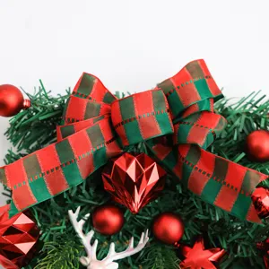 Christmas tree hanging decoration with red green plaid bow and shiny ornaments for holiday.
