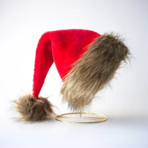 Red plush Christmas hat with brown faux fur trim and pom-pom for holiday party adults.
