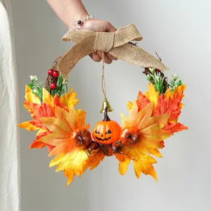 Halloween autumn maple leaf wreath with burlap bow and pumpkin decor for front door home holiday.