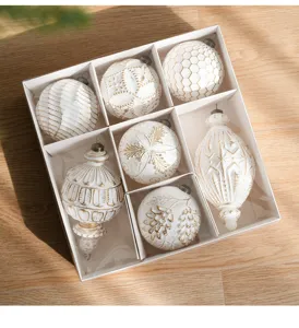 Close-up detail of white and gold Christmas ornaments, vintage matte baubles in gift box.
