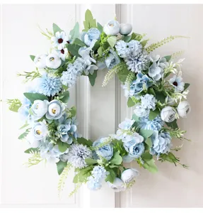 Close-up detail of blue artificial peony and hydrangea flower wreath for home decor scene.