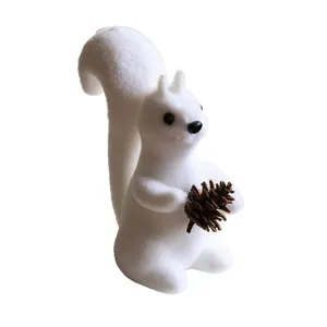 White flocked squirrel figurine holding pinecone Christmas home decoration ornament main