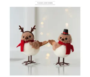 Close-up detail of cute fuzzy couple birds with red scarves and festive accessories for decor.