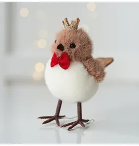 Close-up detail of the cute plush bird ornament with a golden crown and red bow tie.
