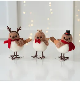 Cute Christmas bird figurines with mini hats and scarves, perfect holiday indoor table decor.