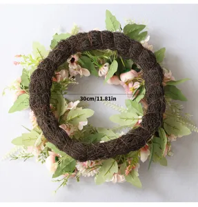 Detailed view of artificial peony flower wreath with brown vine base and pink flowers, 30cm