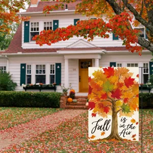 Outdoor autumn garden flag detail showing vibrant maple tree design and rustic text style.