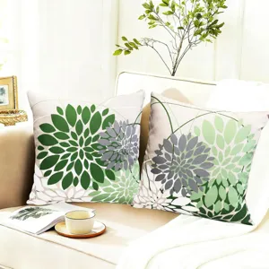 Close-up detail of geometric floral throw pillow cover on modern sofa, cozy home decor scene.