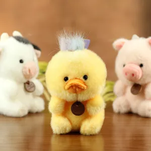 Cute yellow duck plush toy keychain and bag charm with soft fur and colorful hair tuft.
