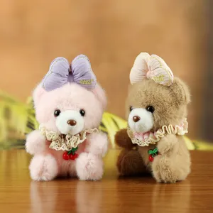 Cute plush bear keychain with lace bow and cherry charm, soft stuffed animal bag pendant.