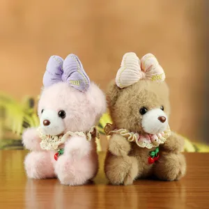 Close-up detail of cute plush teddy bear toys with lovely bows and lace collars.