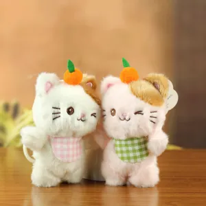 Cute plush cat keychain detail, fluffy toy with orange decor and checkered bib pendant.