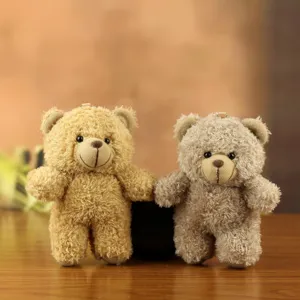 Close-up of cute plush teddy bear keychains, soft fuzzy texture, double bear pendant detail for bags.