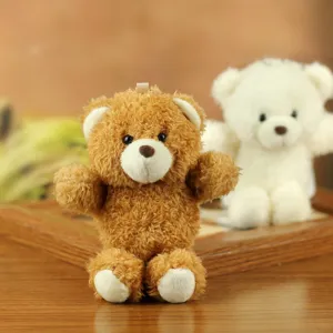 Close-up detail of cute plush bear pendant and soft stuffed doll for bag decoration