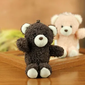 Cute fluffy brown bear plush toy keychain detail shot with soft fabric and metal clasp.