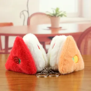 Close-up detail of cute triangle fruit bread plush toy keychain, soft plush hanging ornament.