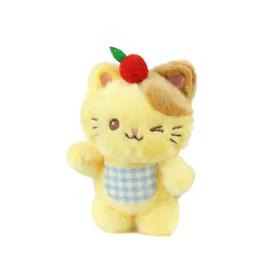Cute yellow kitten plush toy keychain pendant with cherry decor and blue checkered bib.