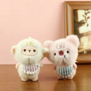 Cute pastoral style plush toy detail view featuring adorable little animal dolls with striped bibs.