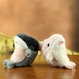 Close-up detail of cute shark seal plush pendant, back-to-back design, soft fabric toy.