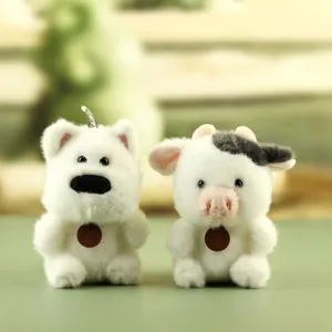 Close-up of cute plush animal toys with soft white fur and neat details for desk decor.