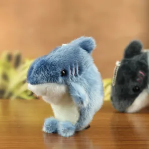 Cute blue shark plush toy keychain pendant, soft fabric detail shot for bags and keys.