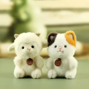 Cute plush toy detail featuring a soft white lamb and a calico cat with cute tags.