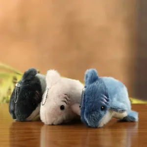 Plush shark keychain detail view, soft toy pendant with bead chain in multi colors.