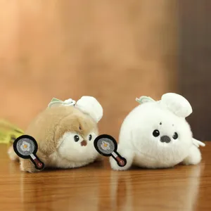 Cute chef sea otter plush toy detail, fluffy pendant with frying pan egg, perfect bag accessory.