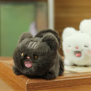 Close-up view of a cute dark grey plush toy pendant showing soft fluffy texture and details.