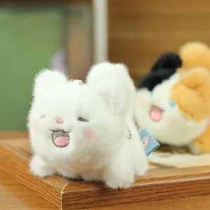 Detailed closeup of a cute white kitten plush toy keychain with soft fluffy fabric.