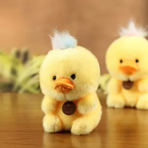 Cute yellow duck plush toy with colorful hair and neck tag, soft stuffed doll pendant accessory.
