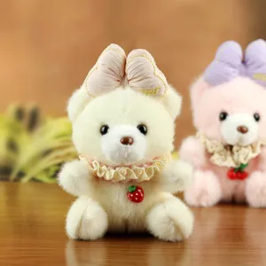 Cute white plush bear keychain with pink bow and strawberry pendant for backpack.