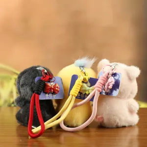 Cute plush animal keychain pendant with hand rope and bow decoration for bags and keys.
