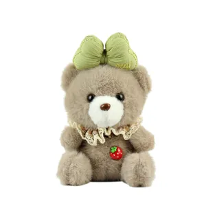 Cute plush bear keychain with green bow and strawberry pendant for cute bag decoration.