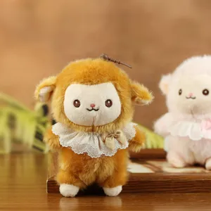 Dettaglio ciondolo pecora in peluche marrone, tessuto morbido, colletto in pizzo, ciondolo borsa.