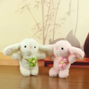 Cute plush rabbit pendant detail, soft fluffy bunny doll with flower ornament on neck.