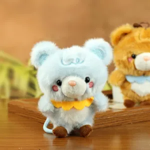 Close-up detail of the cute blue plush bear pendant showing soft fabric, cute face, and collar.