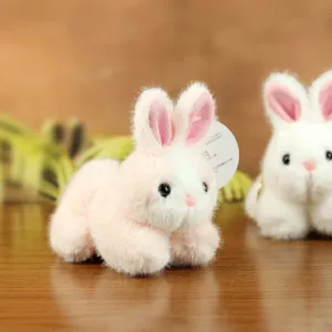 Cute fluffy rabbit plush toy detail shot, adorable stuffed bunny doll pendant for girls.