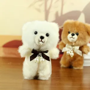 Cute plush teddy bear pendant detail shot showing soft fur texture and elegant pearl bow knot.