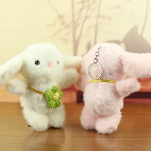 Plush bunny keychain detail, soft stuffed rabbit toy pendant with cute flower, bag charm.