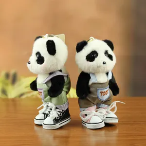 Cute plush panda keychain doll wearing trendy overalls and miniature canvas sneakers.